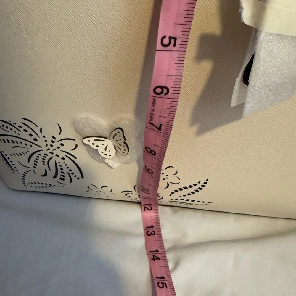 kate spade Cream Tote with Decorative Cutouts and Scarf Accent